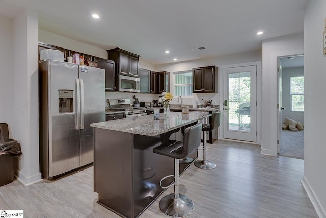 321 Aldworth Ln, Fountain Inn, SC 29644 - kitchen featuring stainless steel appliances, baseboards, dark brown cabinets, light wood-style flooring, and recessed lighting