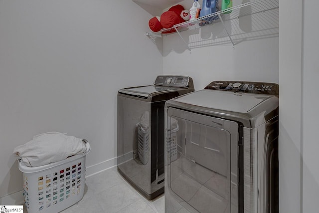 321 Aldworth Ln, Fountain Inn, SC 29644 - clothes washing area with separate washer and dryer, light tile patterned floors, and baseboards