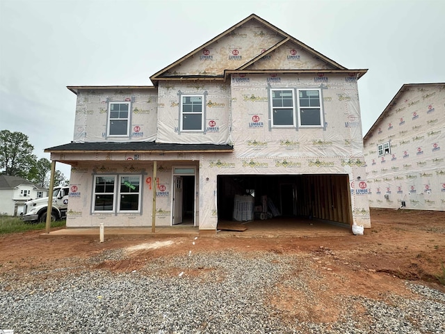 property in mid-construction with a garage, driveway, and covered porch