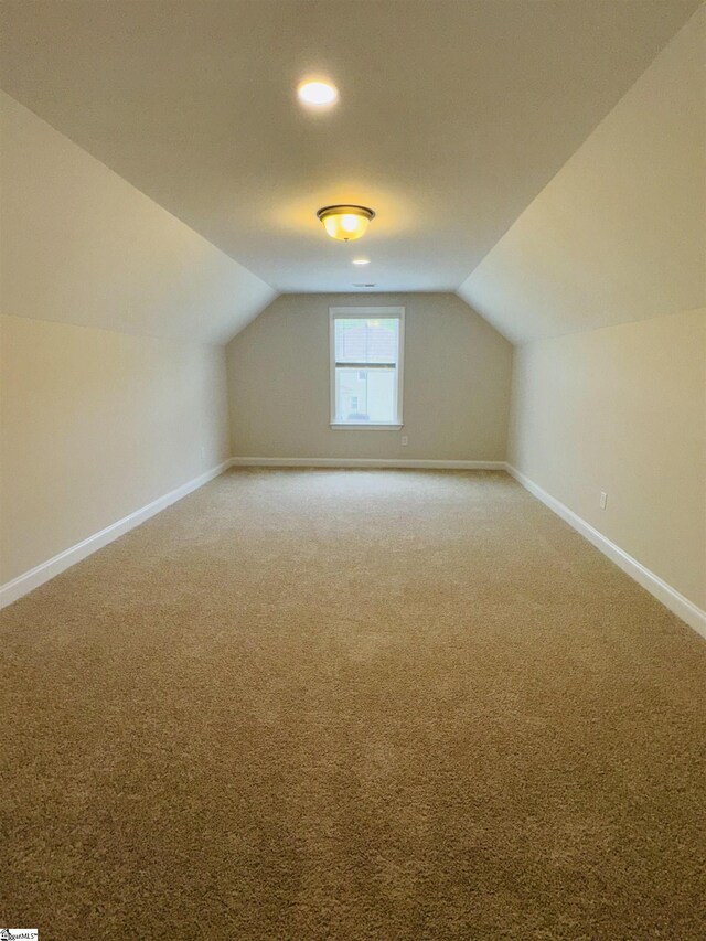 bonus room featuring vaulted ceiling, baseboards, light carpet, and recessed lighting