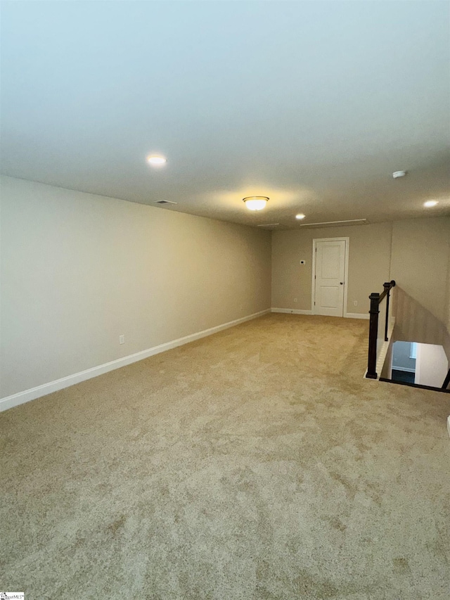 basement featuring carpet floors, baseboards, and recessed lighting