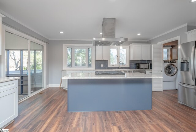4 Pebble Creek Ct, Taylors, SC 29687 - kitchen featuring black appliances, washer / dryer, island exhaust hood, ornamental molding, and backsplash