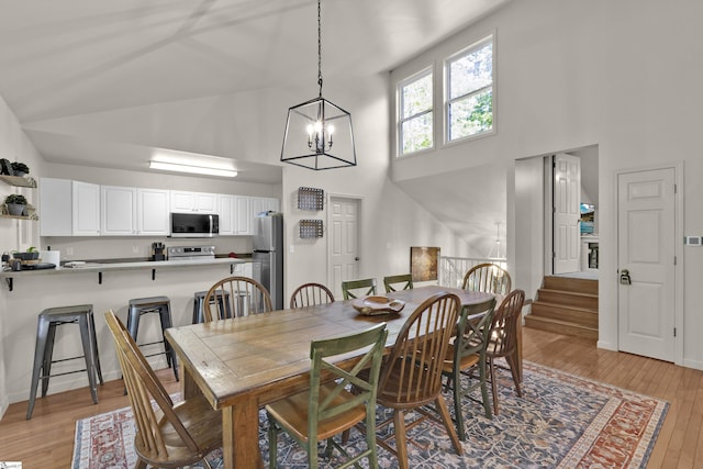 451 Cedar Creek Rd, Sunset, SC 29685 - dining room with a chandelier, high vaulted ceiling, light wood finished floors, and stairway