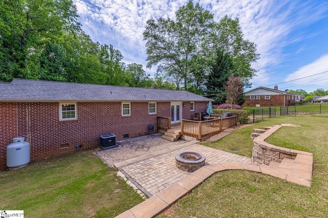 rear view of house with a fire pit, a patio, crawl space, a deck, and central air condition unit