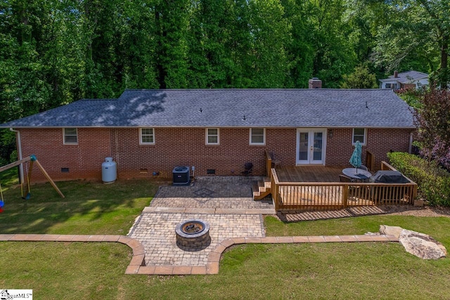 back of house with an outdoor fire pit, crawl space, french doors, a deck, and roof with shingles