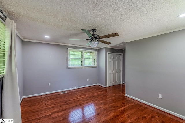 unfurnished room with crown molding, wood finished floors, a ceiling fan, a textured ceiling, and baseboards