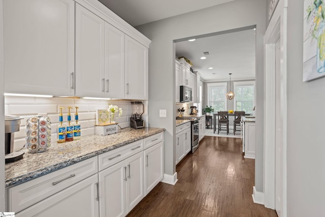 916 Lockhurst Dr, Simpsonville, SC 29681 - kitchen with stainless steel appliances, white cabinetry, dark wood-type flooring, backsplash, and recessed lighting