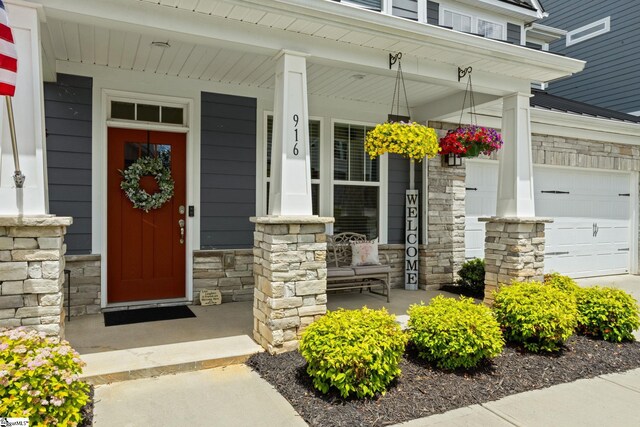 916 Lockhurst Dr, Simpsonville, SC 29681 - doorway to property featuring stone siding, covered porch, and a garage