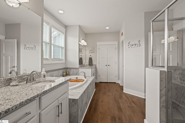 916 Lockhurst Dr, Simpsonville, SC 29681 - full bath with wood finished floors, a stall shower, a bath, vanity, and recessed lighting