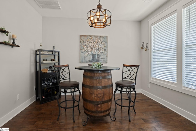 916 Lockhurst Dr, Simpsonville, SC 29681 - dining area featuring a chandelier, dark wood finished floors, and baseboards