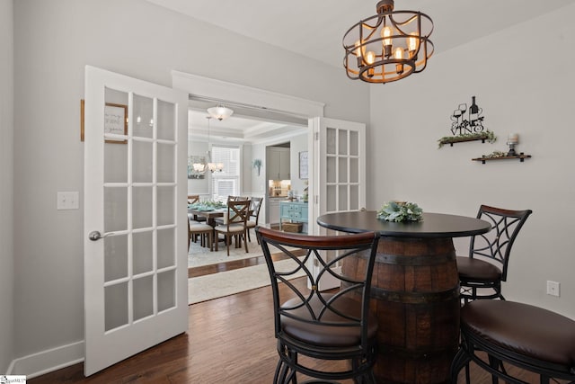 916 Lockhurst Dr, Simpsonville, SC 29681 - dining room featuring a chandelier, dark wood-style floors, and baseboards