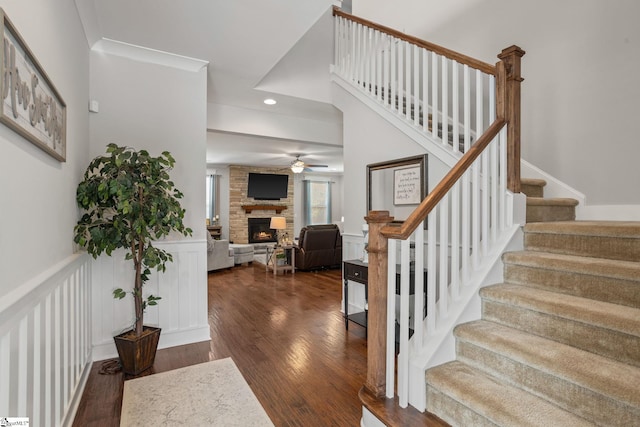 916 Lockhurst Dr, Simpsonville, SC 29681 - staircase featuring a ceiling fan, wood finished floors, a fireplace, recessed lighting, and wainscoting