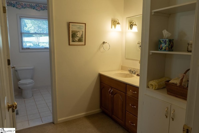 bathroom featuring vanity, toilet, tile patterned flooring, and baseboards