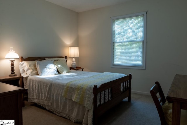 carpeted bedroom featuring baseboards