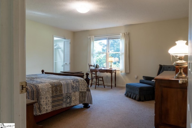 bedroom featuring carpet floors and a textured ceiling