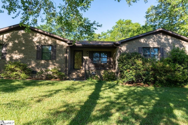 single story home featuring a front lawn, brick siding, and crawl space