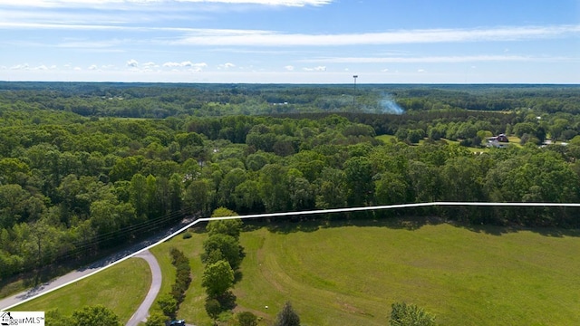 aerial view of property's location featuring a forest and property boundaries highlighted