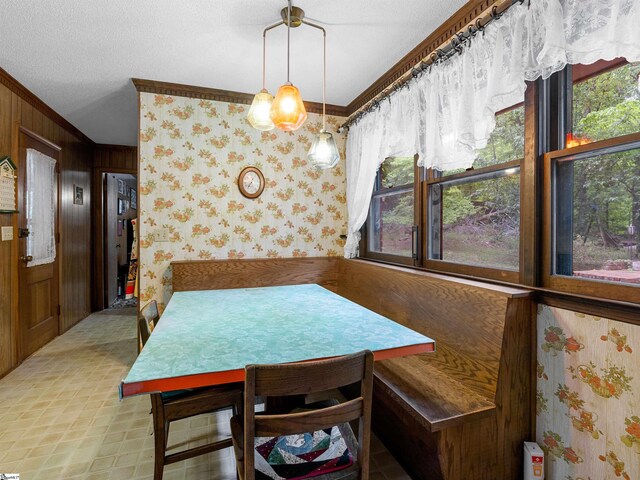 132 Rosecrest Rd, Spartanburg, SC 29303 - dining area featuring wood walls, ornamental molding, wallpapered walls, and a textured ceiling