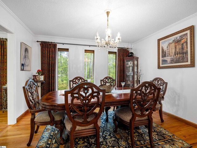 132 Rosecrest Rd, Spartanburg, SC 29303 - dining space with a chandelier, light wood finished floors, healthy amount of natural light, crown molding, and baseboards