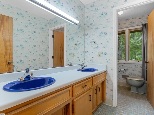132 Rosecrest Rd, Spartanburg, SC 29303 - bathroom featuring toilet, tile patterned floors, double vanity, and wallpapered walls
