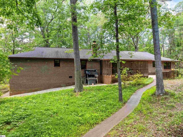 132 Rosecrest Rd, Spartanburg, SC 29303 - back of property with brick siding, a yard, a chimney, and a shingled roof