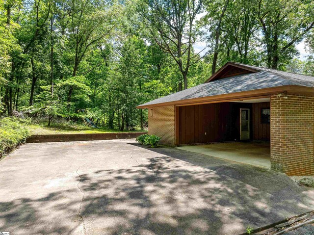 132 Rosecrest Rd, Spartanburg, SC 29303 - view of property exterior with brick siding, driveway, and roof with shingles