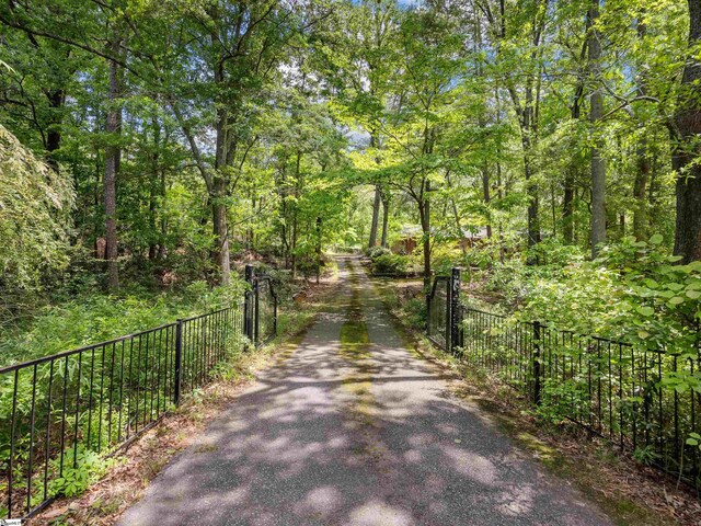 132 Rosecrest Rd, Spartanburg, SC 29303 - view of dirt / gravel driveway with a forest view and a gated entry