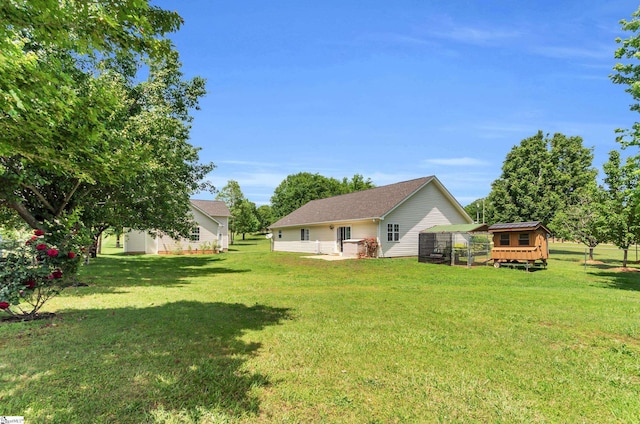 477 Perry Rd, Greer, SC 29651 - rear view of house featuring exterior structure, an outbuilding, and a yard