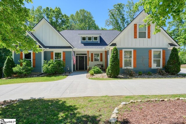 2007 Edwards Lake Rd, Greer, SC 29651 - view of front facade featuring board and batten siding, roof with shingles, and a front yard