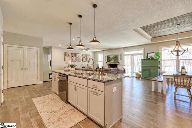 2007 Edwards Lake Rd, Greer, SC 29651 - kitchen with a sink, dishwasher, a center island with sink, a ceiling fan, and light wood-style floors