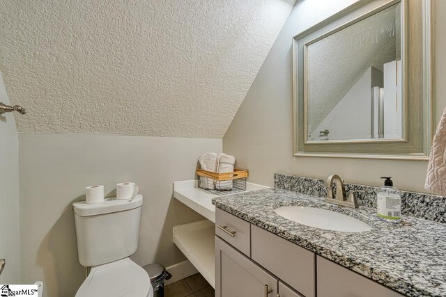 2007 Edwards Lake Rd, Greer, SC 29651 - half bath with vaulted ceiling, a textured ceiling, vanity, toilet, and tile patterned floors