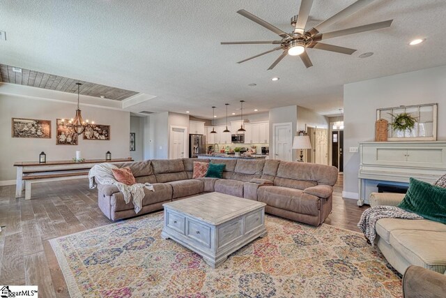 2007 Edwards Lake Rd, Greer, SC 29651 - living room with baseboards, a chandelier, ceiling fan, light wood-style floors, and recessed lighting