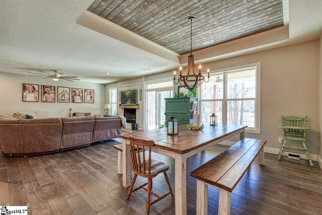 2007 Edwards Lake Rd, Greer, SC 29651 - dining area with dark wood finished floors, a chandelier, a fireplace, baseboards, and a ceiling fan