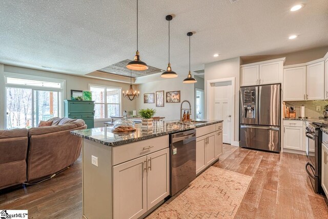 2007 Edwards Lake Rd, Greer, SC 29651 - kitchen with appliances with stainless steel finishes, open floor plan, light wood-style floors, dark stone countertops, and recessed lighting