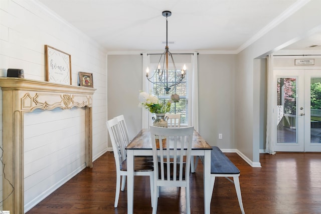 dining area with a chandelier, ornamental molding, wood finished floors, baseboards, and french doors
