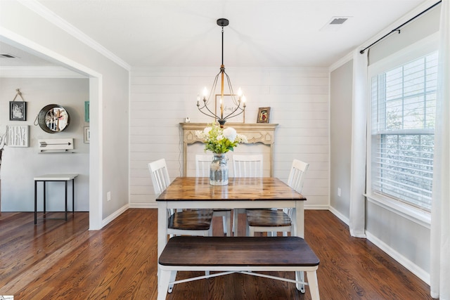 dining area featuring a chandelier, wood finished floors, baseboards, and ornamental molding
