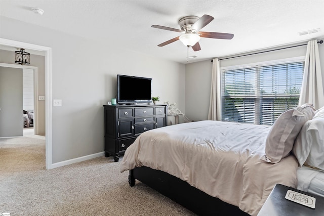 carpeted bedroom with baseboards and ceiling fan