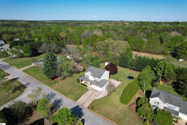 aerial view of property's location featuring a forest