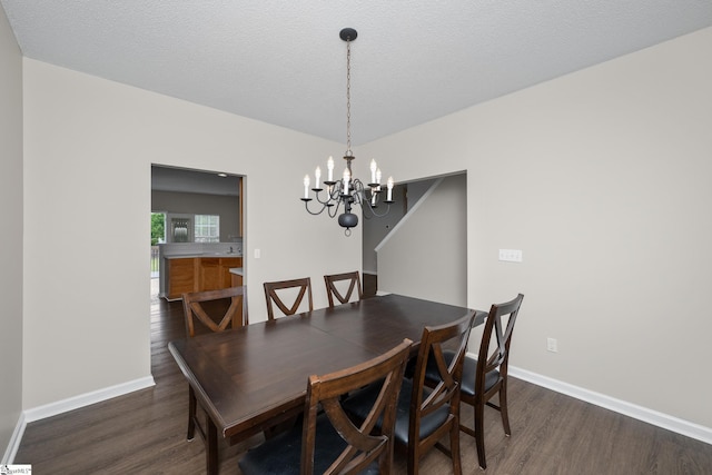 dining room with a chandelier, wood finished floors, and baseboards