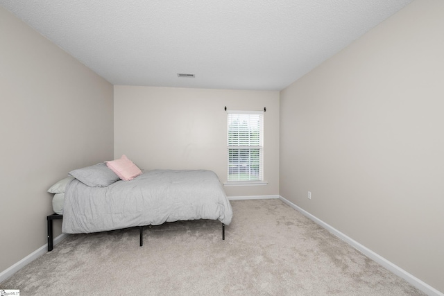 carpeted bedroom featuring baseboards