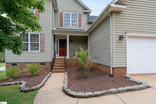entrance to property with crawl space and an attached garage
