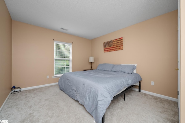 carpeted bedroom featuring baseboards