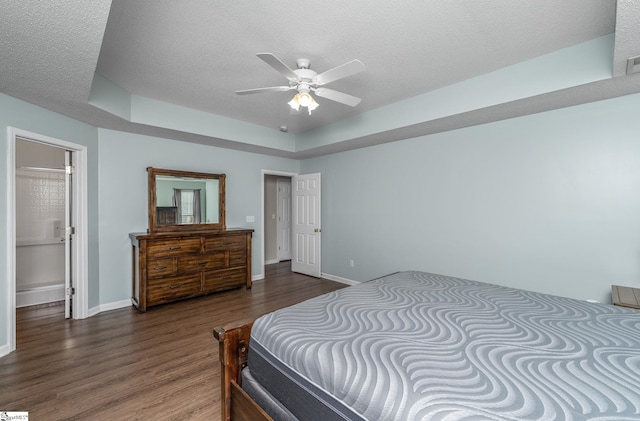 bedroom featuring wood finished floors, a textured ceiling, baseboards, and a ceiling fan