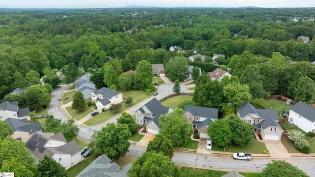 aerial perspective of suburban area with a heavily wooded area