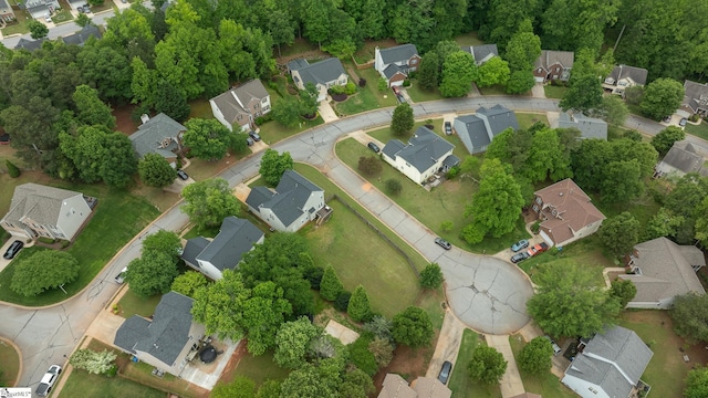 aerial view of property and surrounding area featuring nearby suburban area