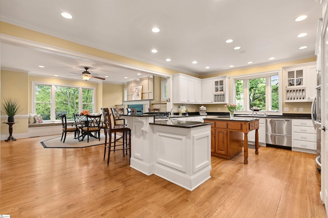 201 King Eider Way, Taylors, SC 29687 - kitchen with dishwasher, a kitchen breakfast bar, crown molding, healthy amount of natural light, and dark countertops