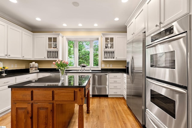 201 King Eider Way, Taylors, SC 29687 - kitchen with appliances with stainless steel finishes, light wood-style floors, white cabinets, glass insert cabinets, and crown molding