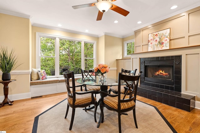 201 King Eider Way, Taylors, SC 29687 - dining area with crown molding, ceiling fan, light wood finished floors, a tile fireplace, and recessed lighting