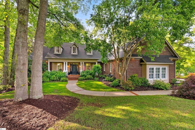 201 King Eider Way, Taylors, SC 29687 - cape cod house featuring a front lawn, brick siding, and covered porch