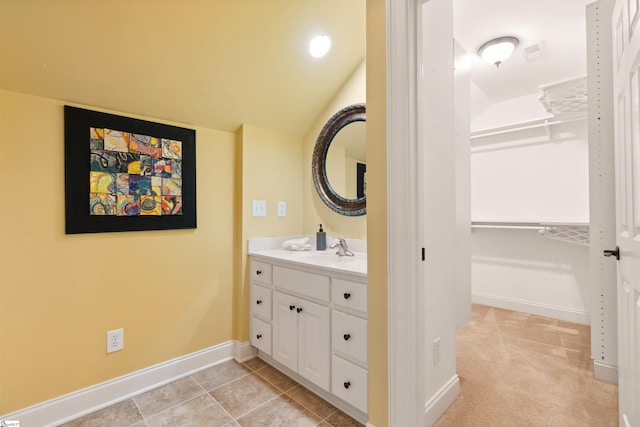 201 King Eider Way, Taylors, SC 29687 - bathroom with vanity, a spacious closet, baseboards, and lofted ceiling